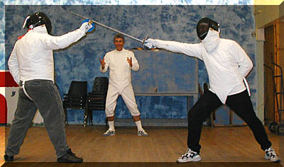 Dennis Fredricks directs a bout between Chris Regenfuss (left)
